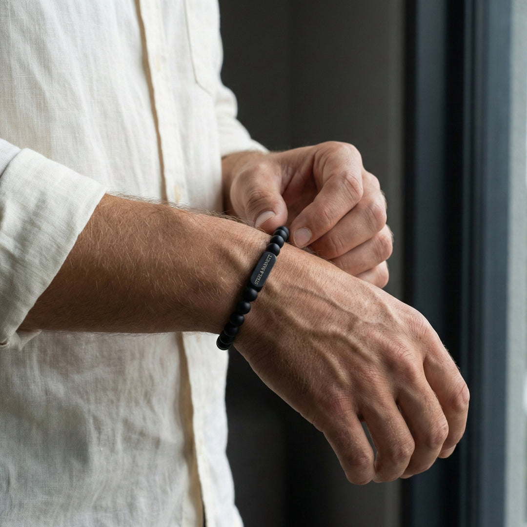 Niche Jewellery Steel & Barnett 6mm black onyx bead bracelet with matte stainless steel accent on a man's wrist