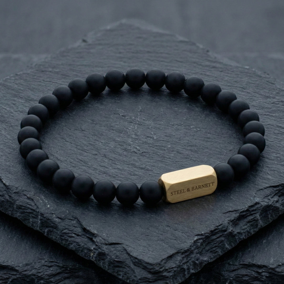 Niche Jewellery Steel & Barnett black onyx bead bracelet with a brushed 18K gold plated stainless steel accent.