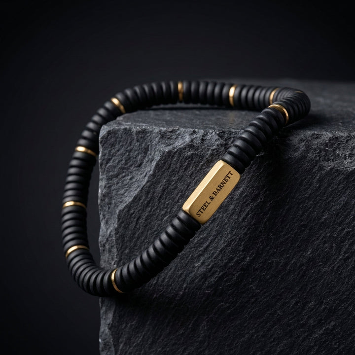 Niche Jewellery Steel & Barnett matte black onyx disc stretch bracelet with 18K gold-plated stainless steel accents.