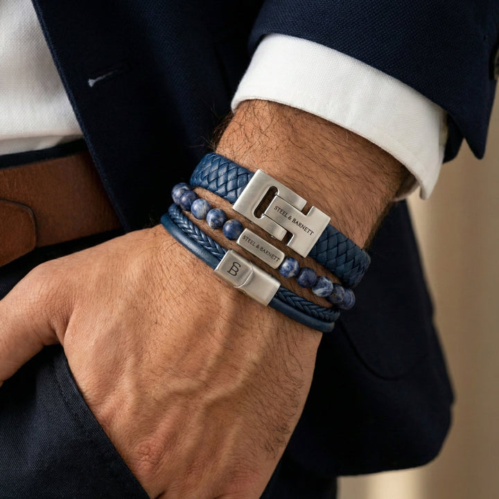Niche Jewellery Steel & Barnett navy blue braided leather, stone bead, and rope bracelet stack with silver accents.
