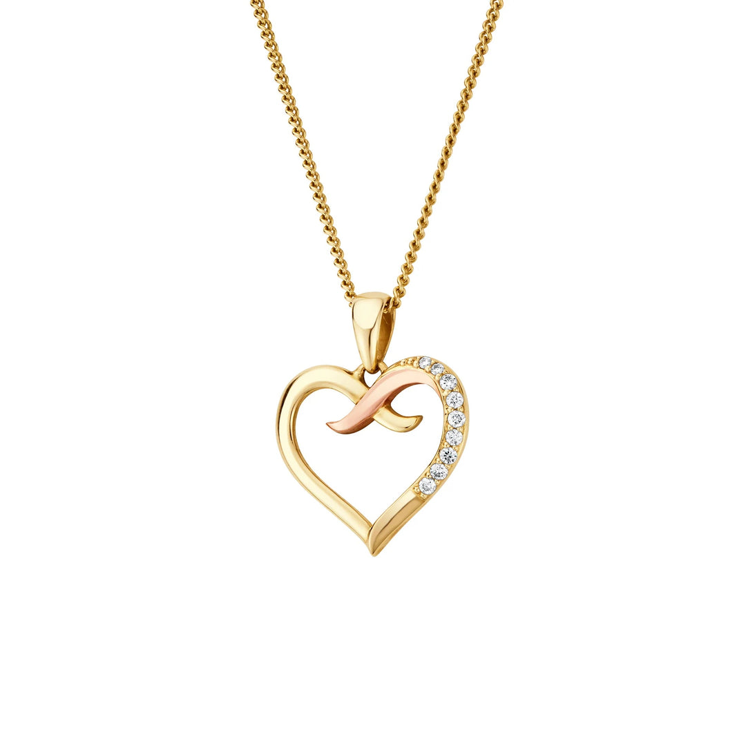 Niche Jewellery Clogau Forever Yours heart pendant in 9ct gold with diamonds and a kiss motif on a delicate chain.