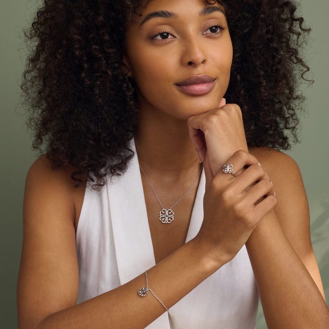 Niche Jewellery Clogau Tree of Life sterling silver heart bracelet worn by a woman with a matching necklace and ring.