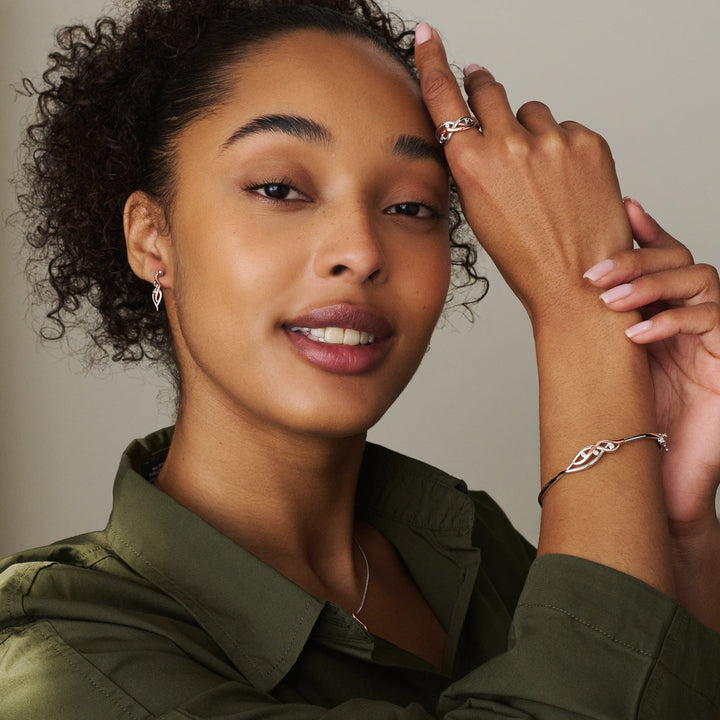 Niche Jewellery Clogau sterling silver and rose gold Swallow Falls ring worn by a woman with matching jewellery