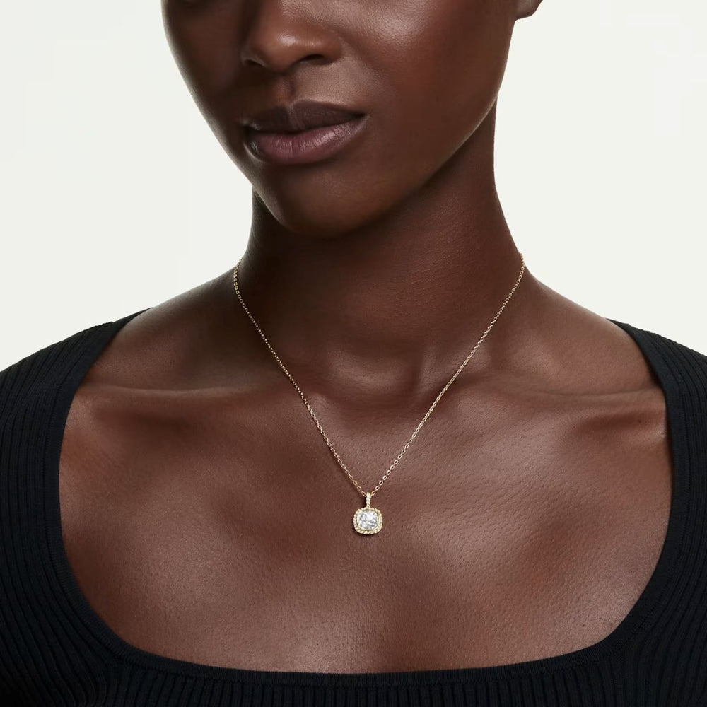 Niche Jewellery Swarovski Una Angelic cushion cut pendant necklace with clear crystal and rhodium plating on a model