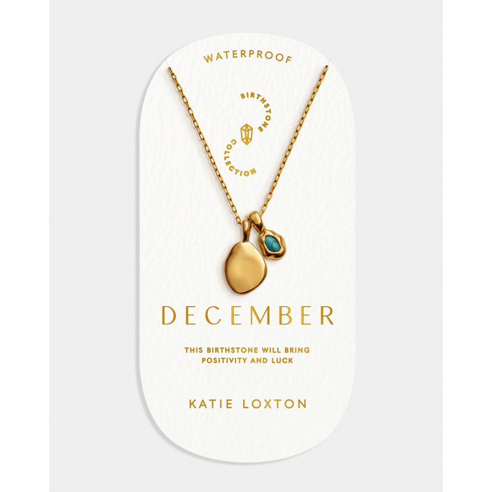 Niche Jewellery Katie Loxton December birthstone necklace with a gold-tone chain and blue stone on display card.