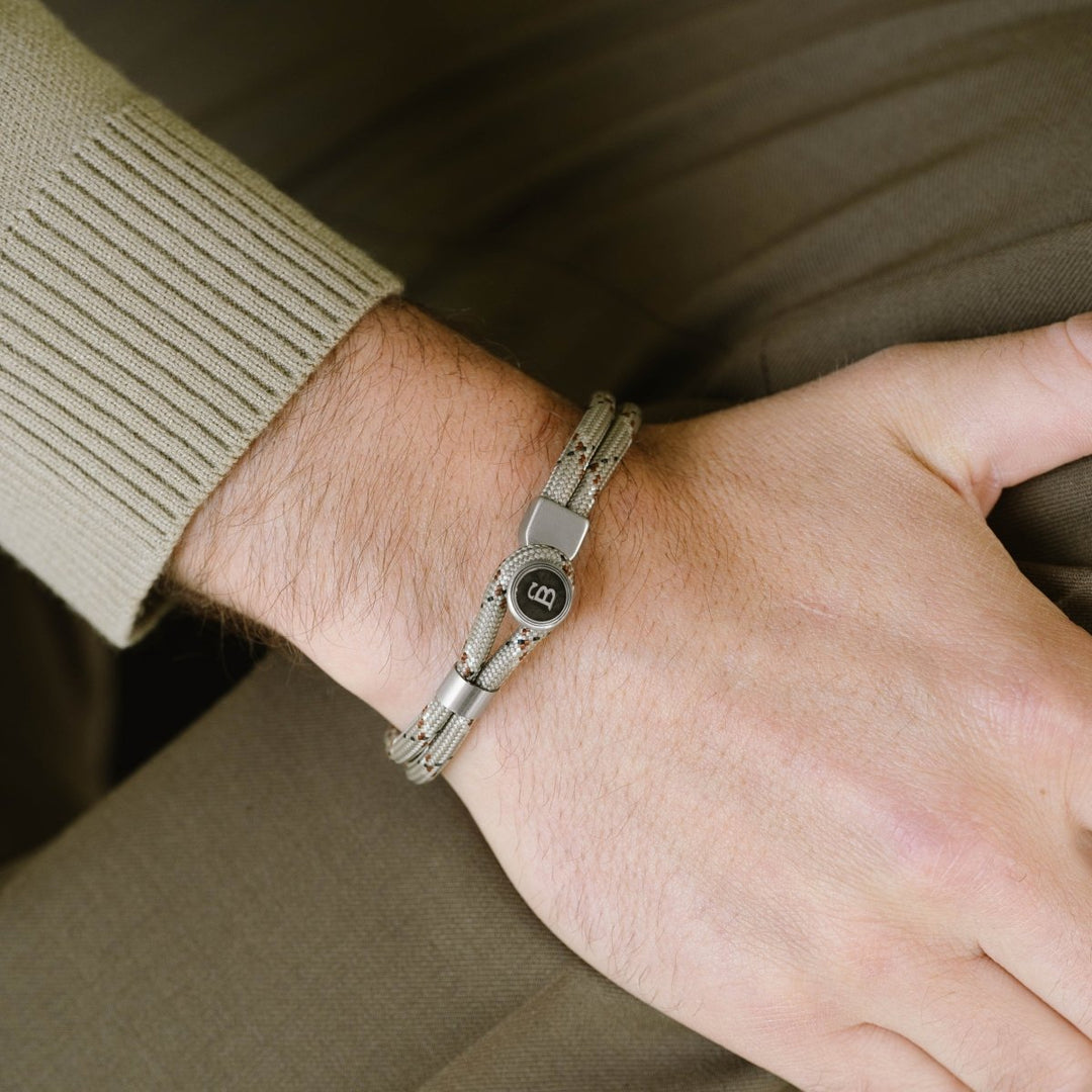 Niche Jewellery Steel & Barnett desert camo rope bracelet with stainless steel clasp on a man's wrist