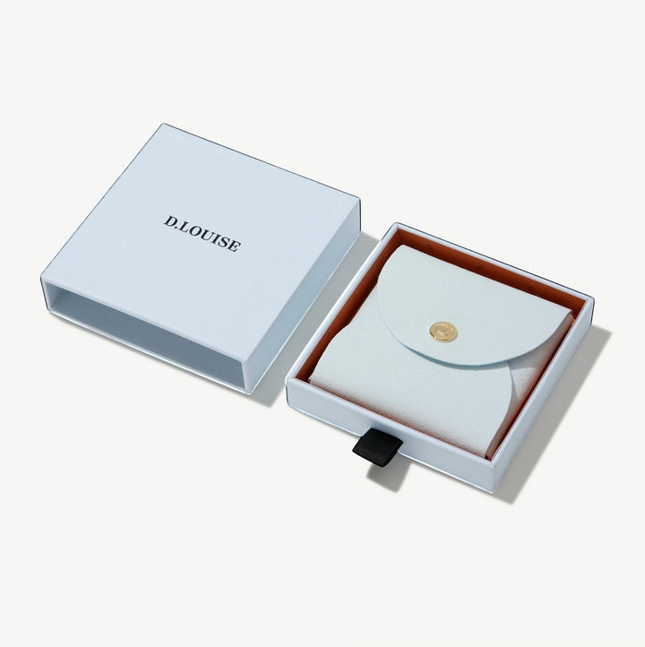 Niche Jewellery D.Louise intertwined mini hoop earrings in a light blue branded gift box with a matching pouch