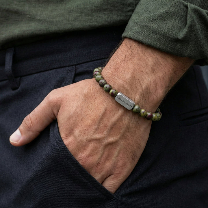 Niche Jewellery Steel & Barnett 6mm dragon's blood jasper bead bracelet with stainless steel tag on a man's wrist