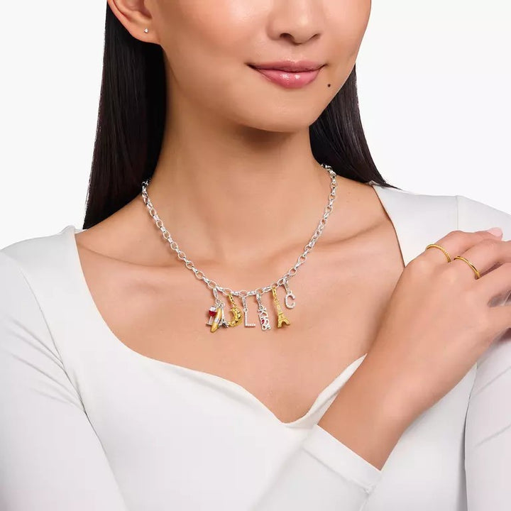 Thomas Sabo gold-plated Eiffel Tower charm pendant with white zirconia on a silver chain necklace.