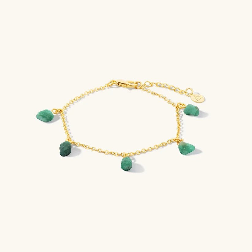 Niche Jewellery Mohica charm bracelet featuring raw-cut emerald gemstones on an 18k gold plated sterling silver chain.