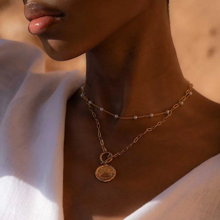 Niche Jewellery Formation Co Gaia pearl necklace featuring freshwater pearls on an 18k gold plated chain with a coin pendant