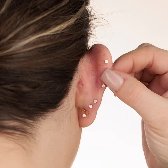 Niche Jewellery gold baguette stud earring with flat back worn in an ear stack