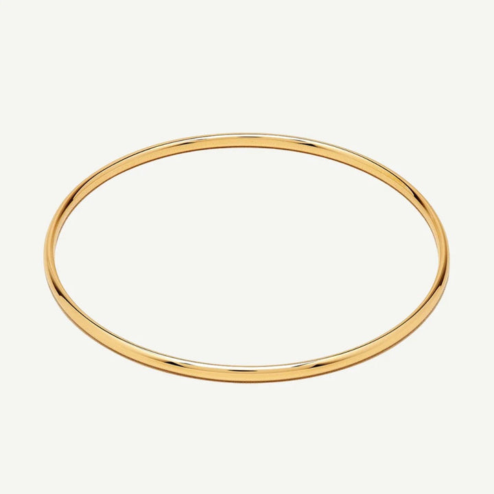 Niche Jewellery classic gold bangle, a versatile and timeless piece for everyday wear or special occasions. Water-resistant.
