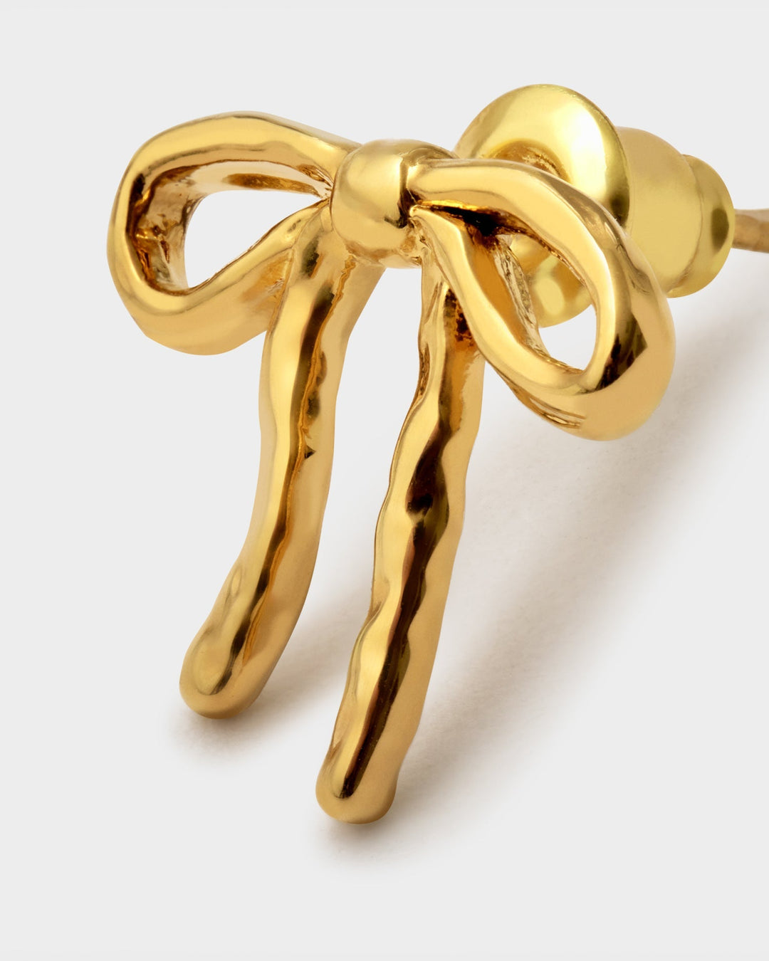 Niche Jewellery Katie Loxton Novelle waterproof gold-tone bow stud earrings with a polished finish.