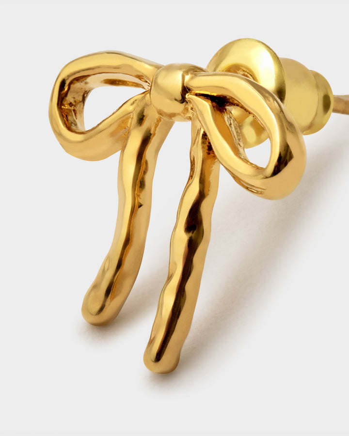 Niche Jewellery Katie Loxton Novelle waterproof gold-tone bow stud earrings with a polished finish.