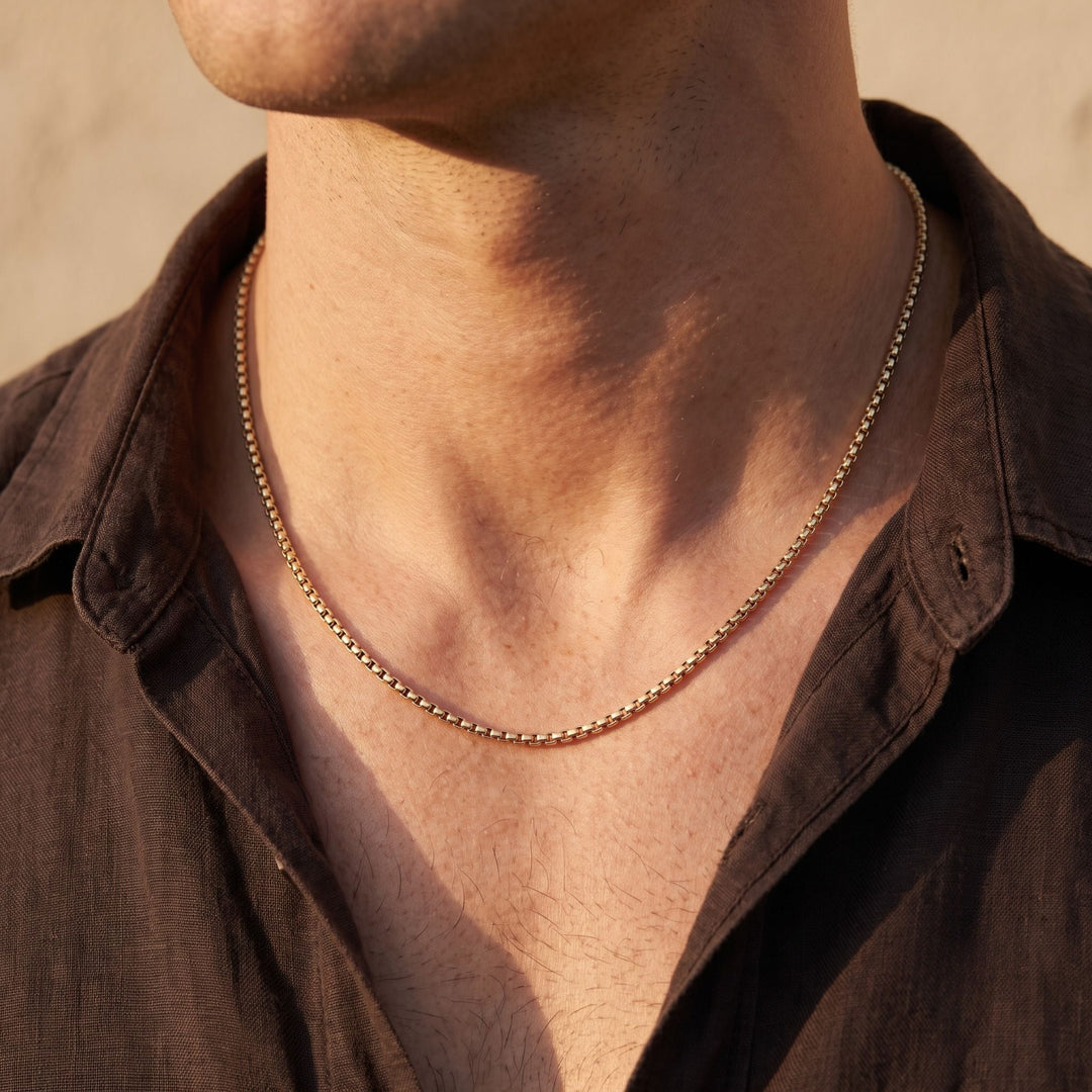 Niche Jewellery Steel & Barnett thin 18K gold plated stainless steel box chain necklace worn by a man.