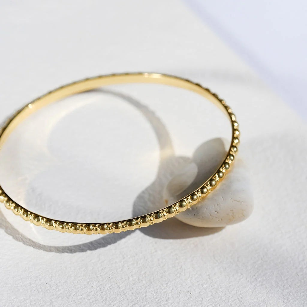 Niche Jewellery Charlotte's Web Maharani gold vermeil stacking bangle with delicate textured bubble detailing.