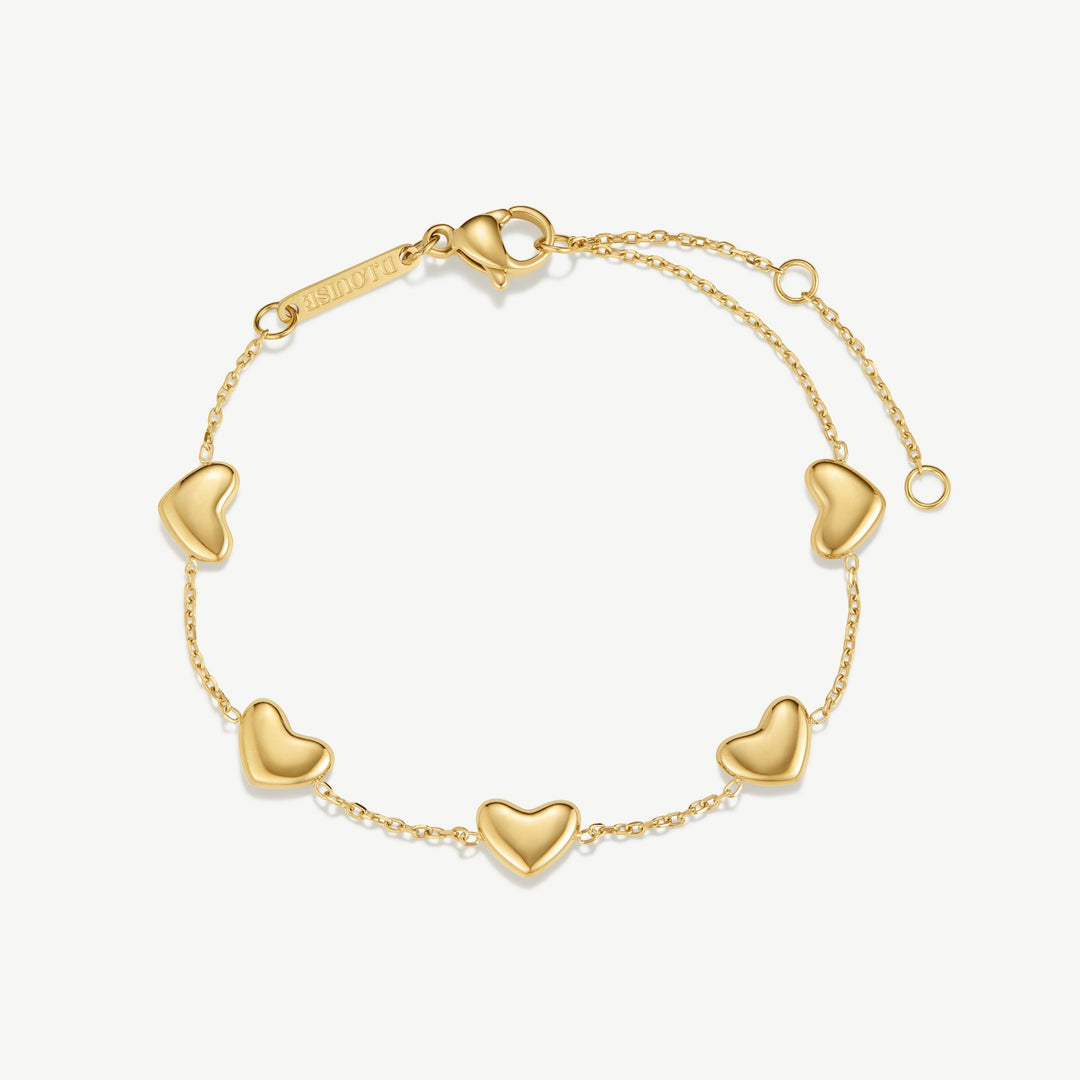 Niche Jewellery gold bracelet with five bubble heart charms on a delicate chain. Adjustable clasp.