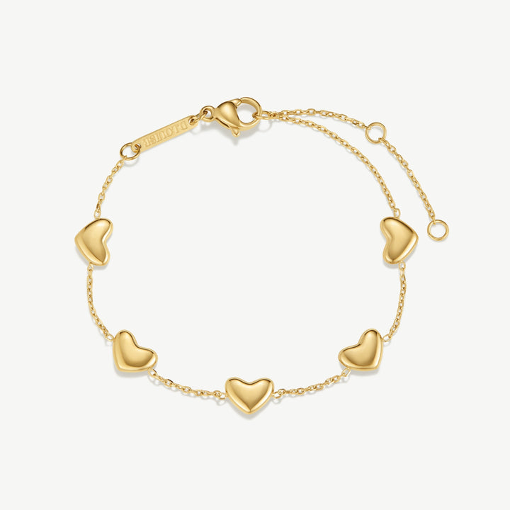 Niche Jewellery gold bracelet with five bubble heart charms on a delicate chain. Adjustable clasp.