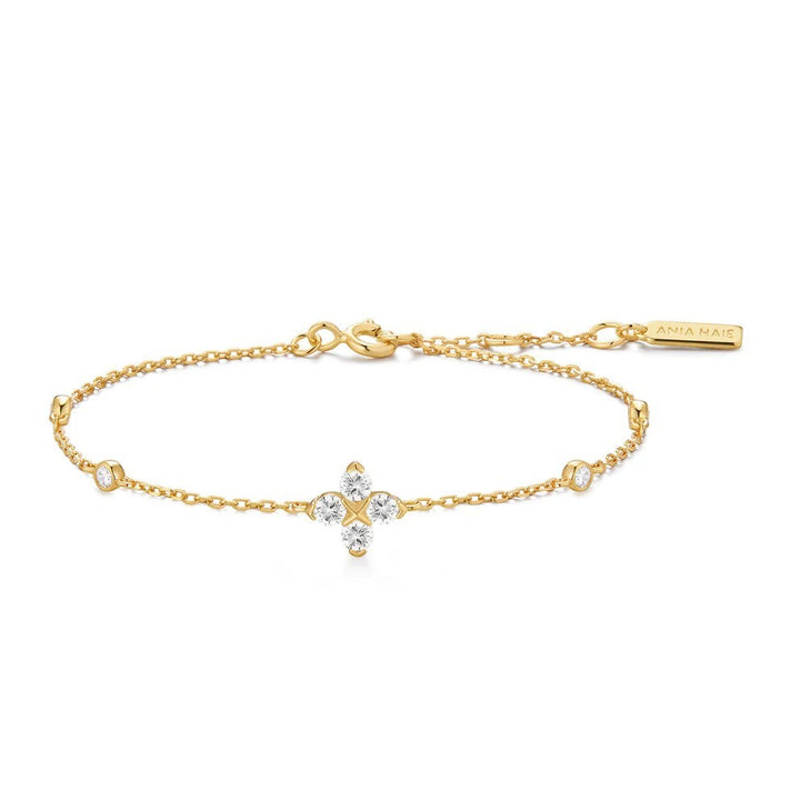 Niche Jewellery Ania Haie gold chain bracelet featuring a sparkling four-leaf clover charm with clear cubic zirconia
