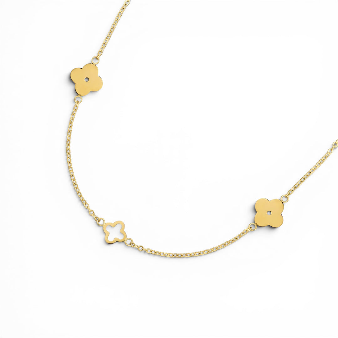 Niche Jewellery D.Louise gold clover necklace with alternating solid and cut-out charms on a delicate chain.