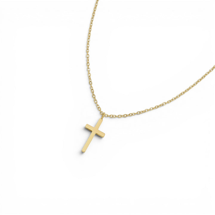 Niche Jewellery D.Louise gold cross pendant necklace on a fine chain, made from waterproof and tarnish-free stainless steel.