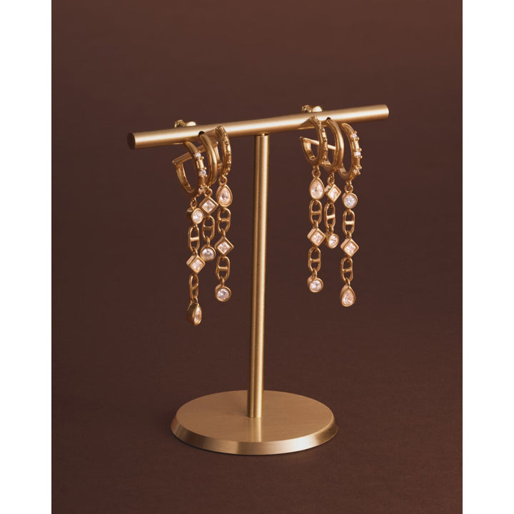 Niche Jewellery Katie Loxton gold drop earrings with sparkling crystal charms on a gold display stand