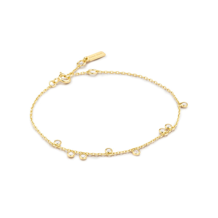 Niche Jewellery Ania Haie gold-plated bracelet with bezel-set cubic zirconia droplet charms on a delicate chain.