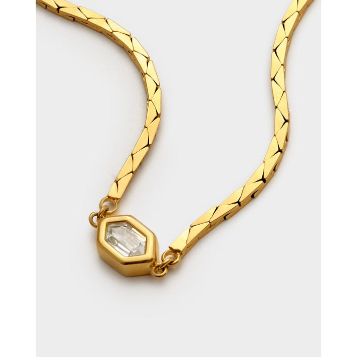 Niche Jewellery Katie Loxton gold-tone waterproof bracelet featuring a diamond-check pattern and a central crystal.