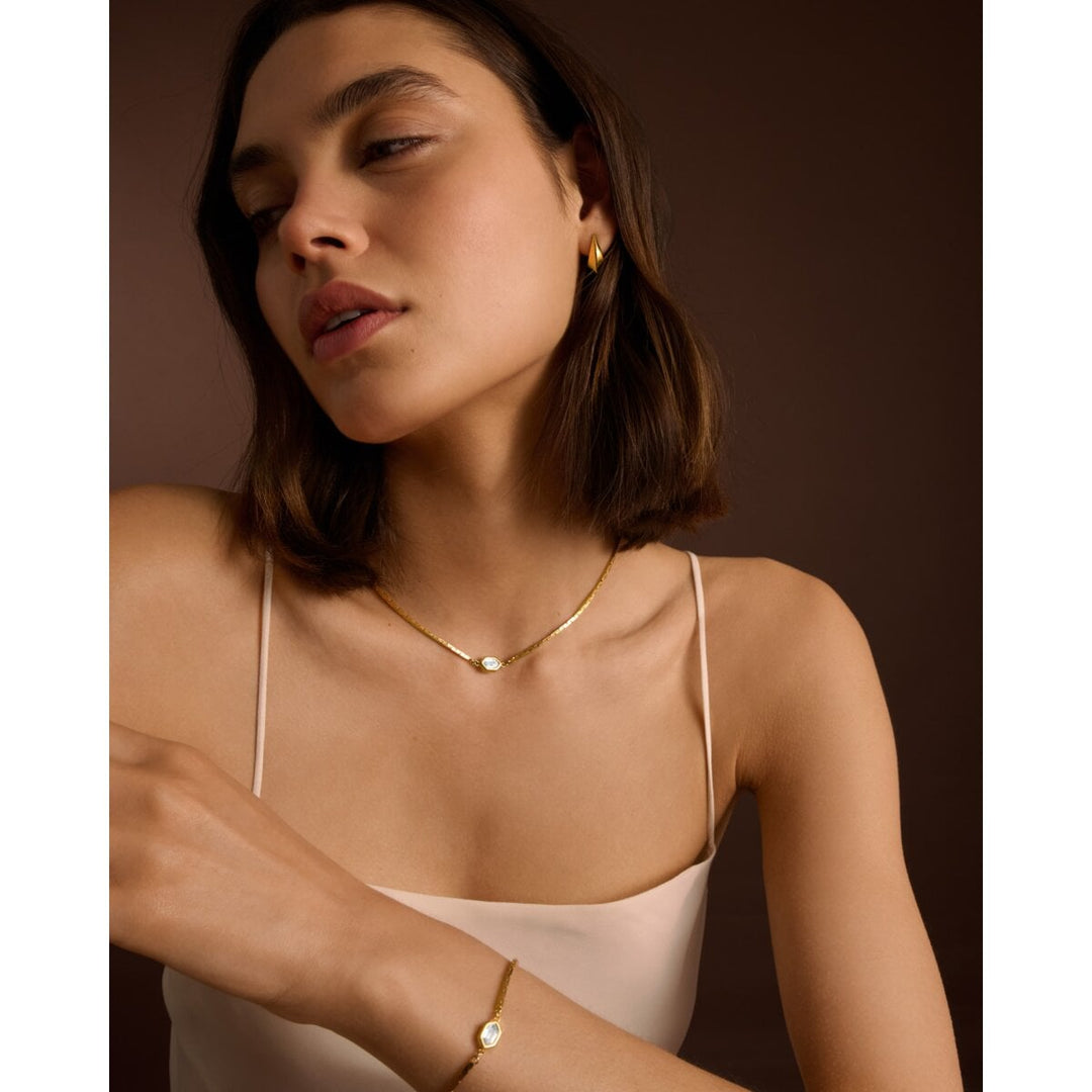 Niche Jewellery Katie Loxton gold-tone waterproof bracelet with diamond-check motif worn by a model