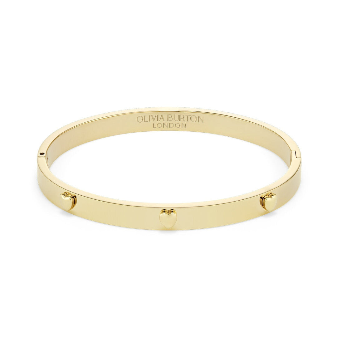 Niche Jewellery Olivia Burton gold-plated bangle featuring delicate mini heart charms on a smooth polished band.