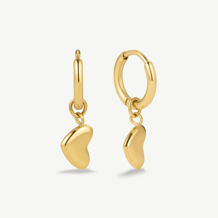 Niche Jewellery gold huggie hoop earrings with dangling bubble heart charms. Waterproof and tarnish-free.