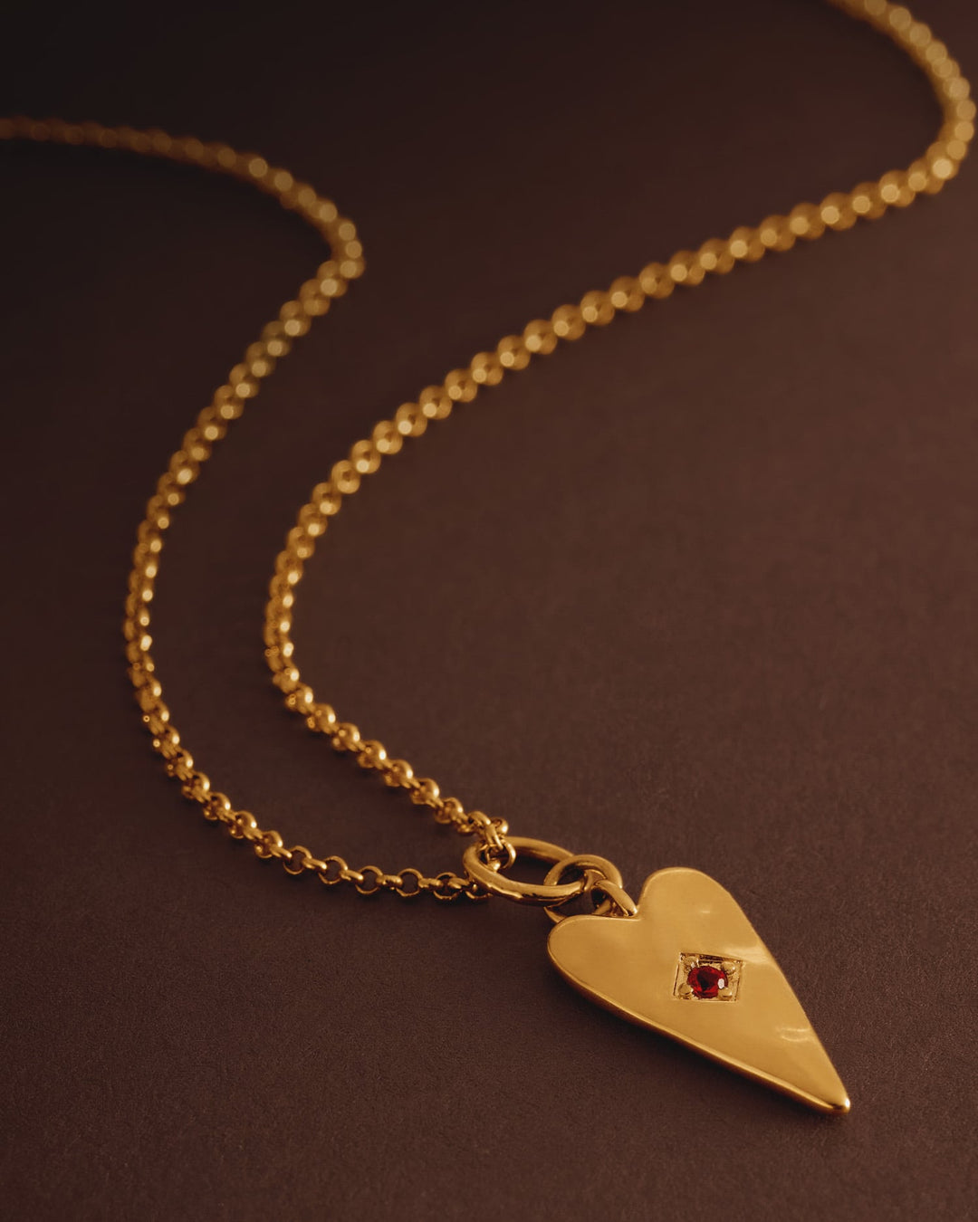 Niche Jewellery Katie Loxton gold-tone heart necklace with a deep red stone accent on a fine chain