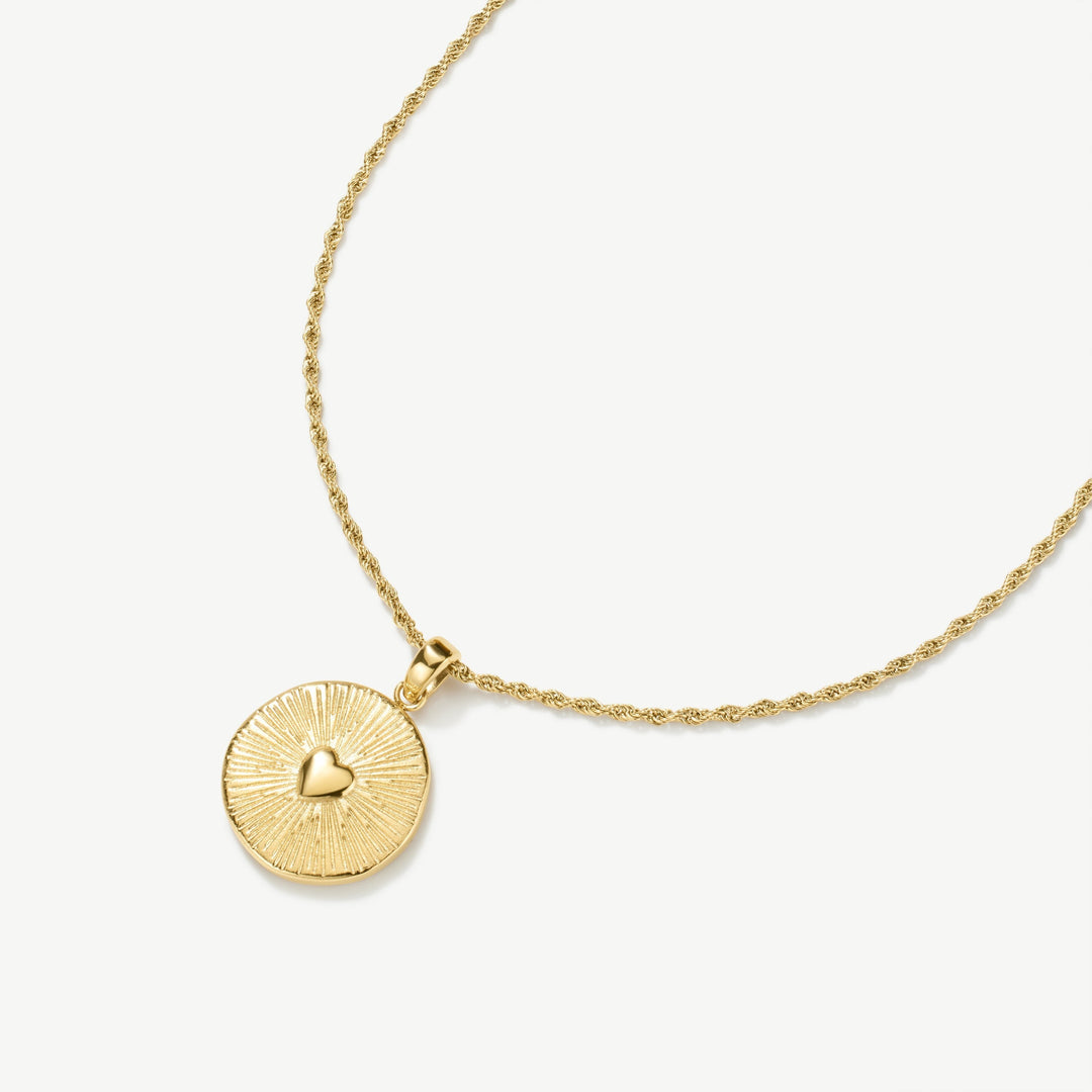 Niche Jewellery gold stainless steel necklace with textured circular pendant and raised heart centre. Waterproof and tarnish-free.