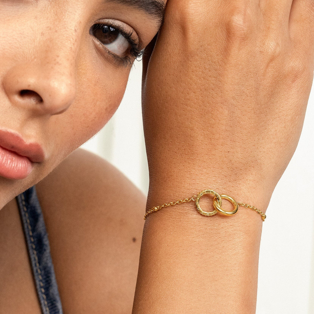 Niche Jewellery Olivia Burton gold-plated Amity interlock bracelet worn on a woman's wrist