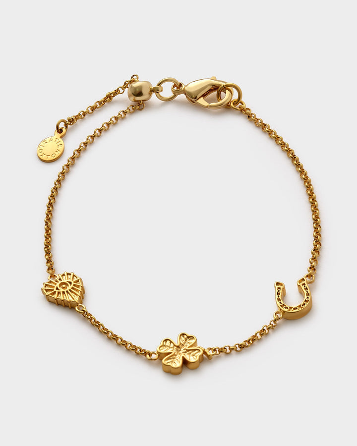 Niche Jewellery Katie Loxton gold-tone waterproof chain bracelet featuring lucky charms like a clover and horseshoe.