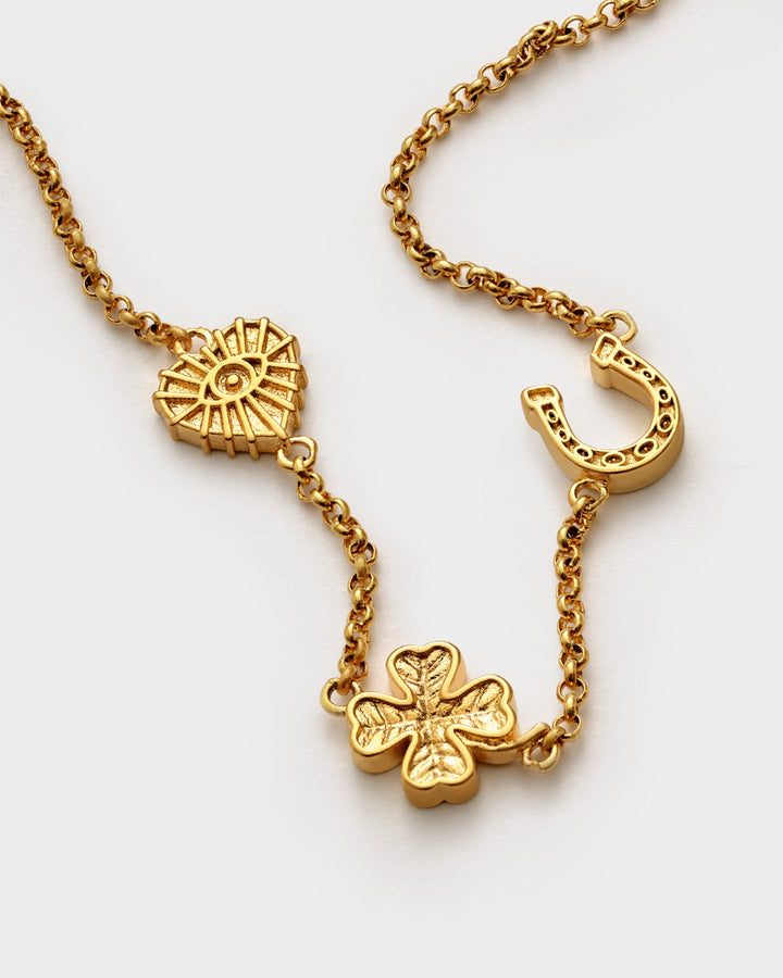 Niche Jewellery Katie Loxton gold-tone waterproof bracelet featuring heart, horseshoe, and clover lucky charms.