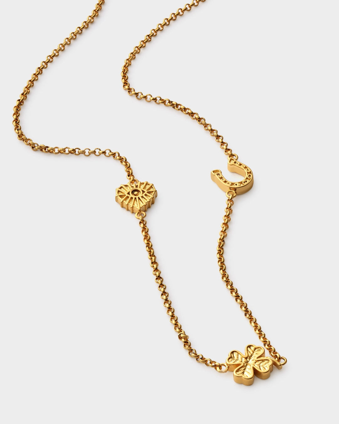 Niche Jewellery Katie Loxton gold-tone waterproof necklace featuring heart, horseshoe, and clover lucky charms.