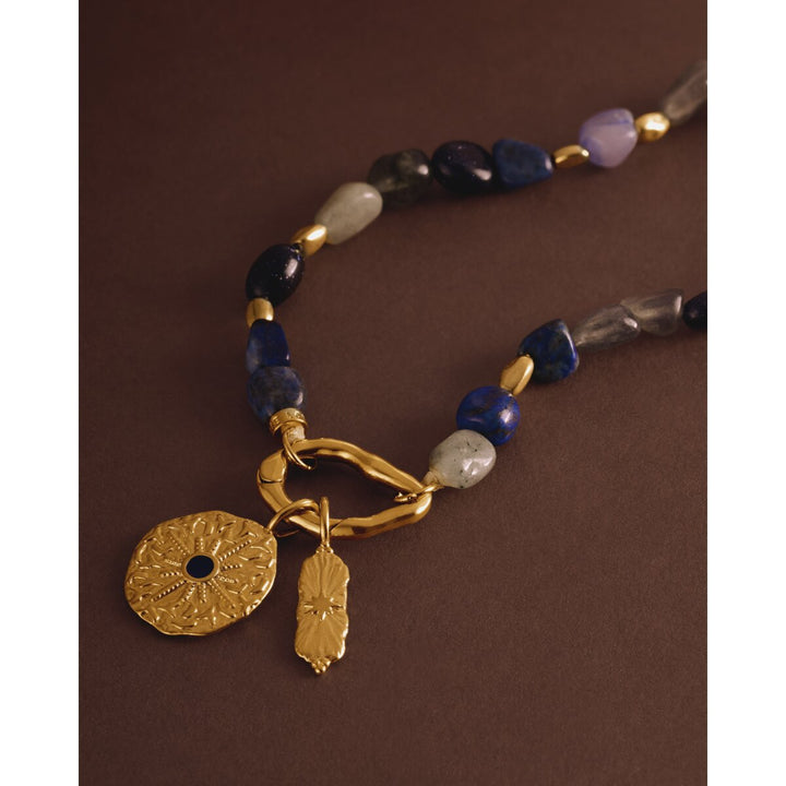 Niche Jewellery Katie Loxton Midnight Solesi waterproof gold bracelet with navy semi-precious stones and coin charms.