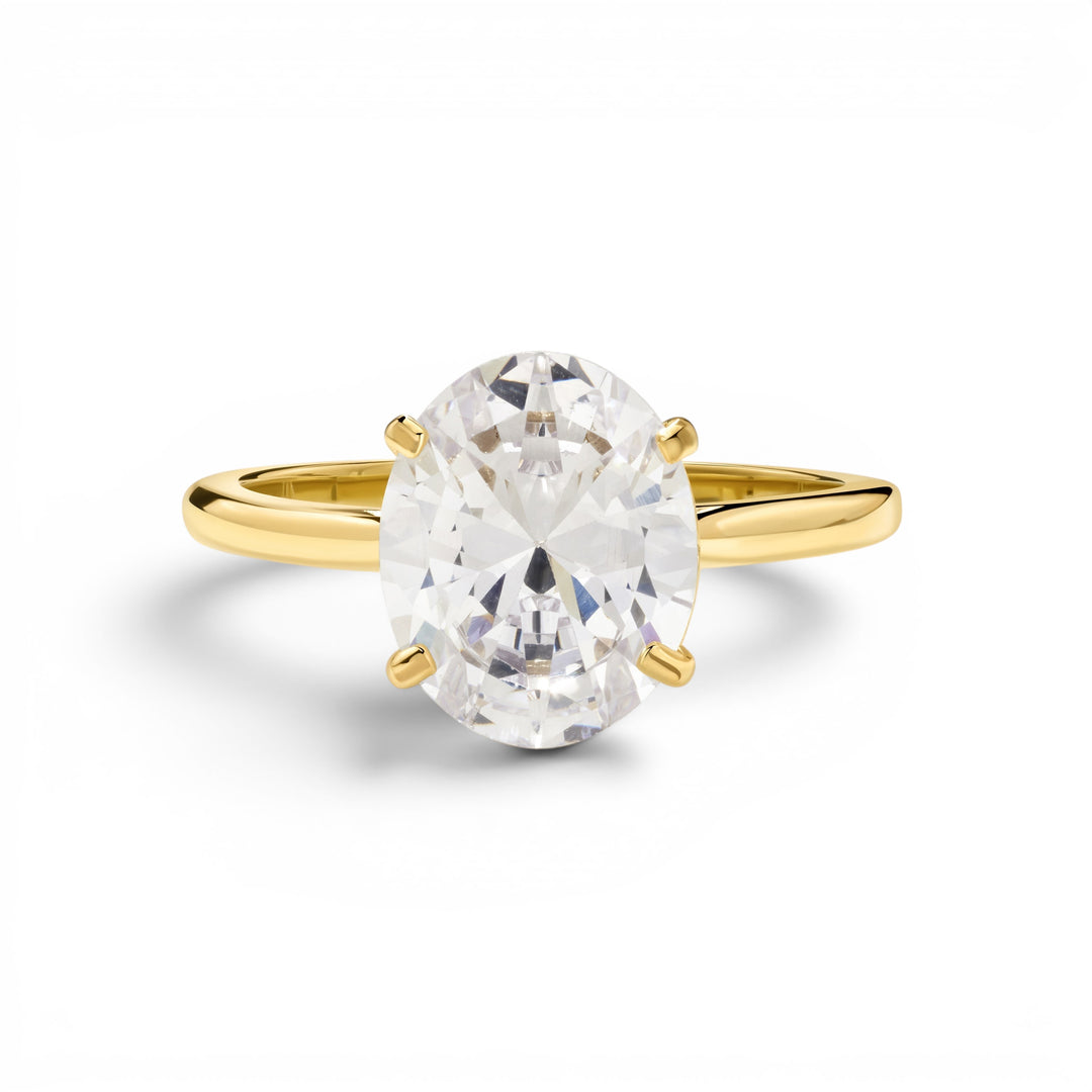 Niche Jewellery oval-cut solitaire travel ring in gold with a clear, sparkling stone. Elegant and waterproof.