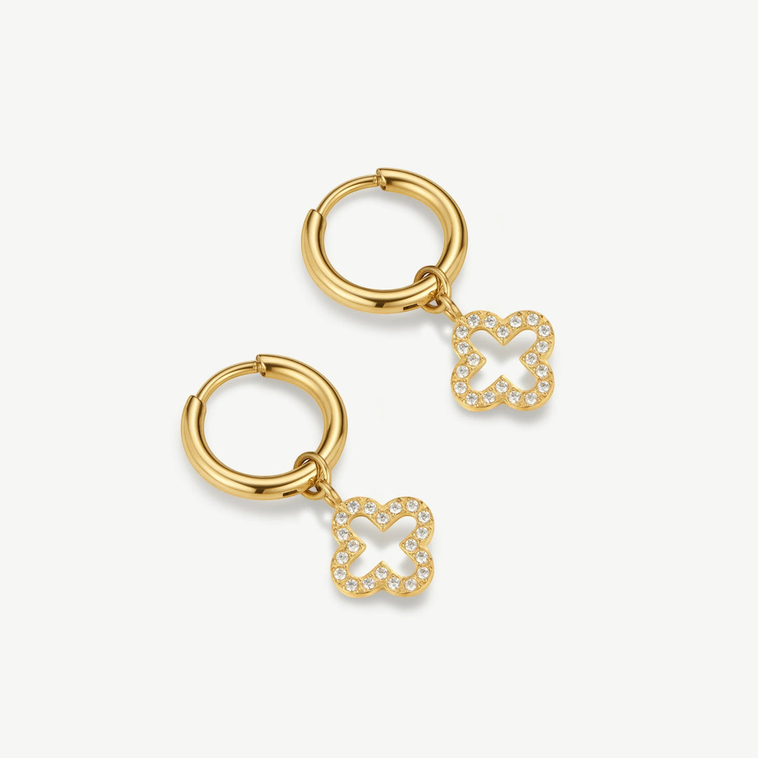 Niche Jewellery D.Louise gold stainless steel huggie hoop earrings featuring a sparkling pave clover drop charm.