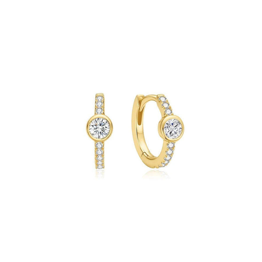 Niche Jewellery Ania Haie gold huggie hoop earrings featuring a row of pavé cubic zirconia and bezel-set stones.