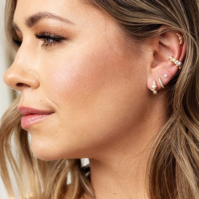 Niche Jewellery Scream Pretty Hannah Martin gold pearl ear cuff worn on a model with a curated ear stack