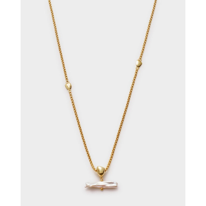 Niche Jewellery Sol Pearl Bar necklace with a freshwater pearl pendant on a gold chain with small gold heart details.