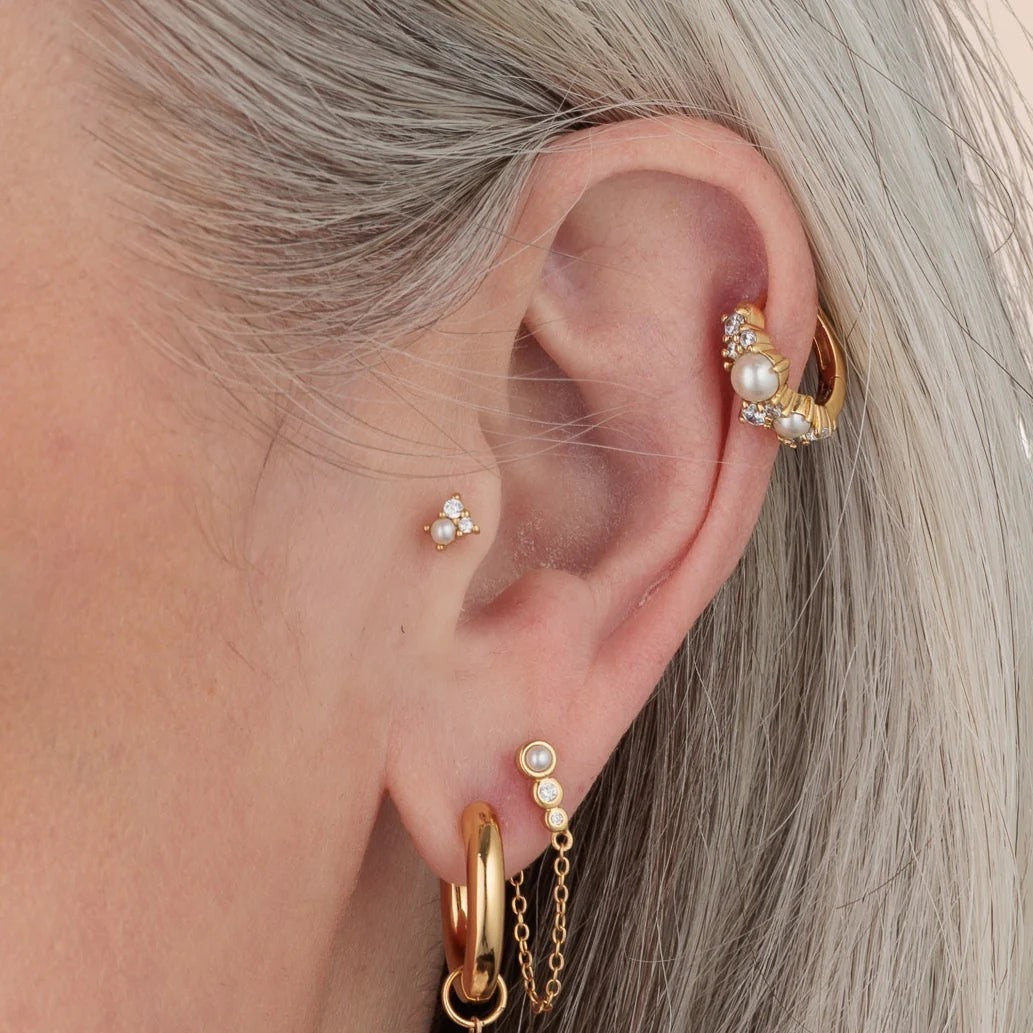 Niche Jewellery Scream Pretty Hannah Martin gold-plated pearl and crystal stud earring worn in a curated ear stack.