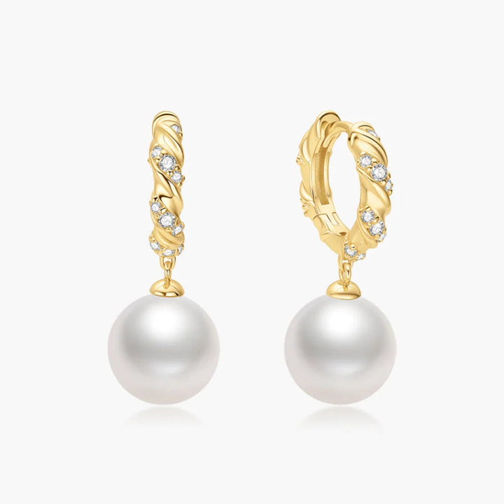Niche Jewellery Ania Haie gold twisted huggie hoop earrings with pavé cubic zirconia and dangling shell pearls.