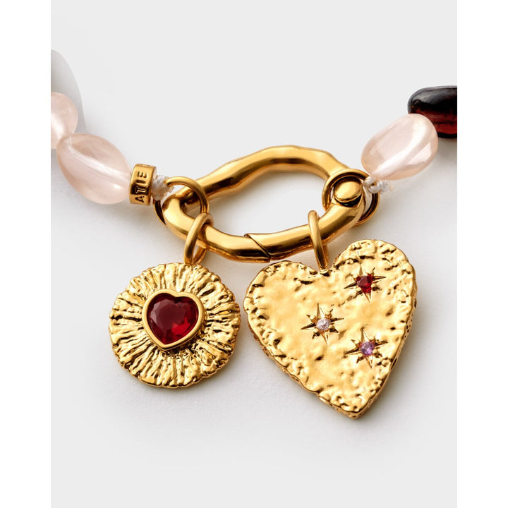 Niche Jewellery Katie Loxton gold-tone waterproof bracelet with pink stones and heart and sunburst charms
