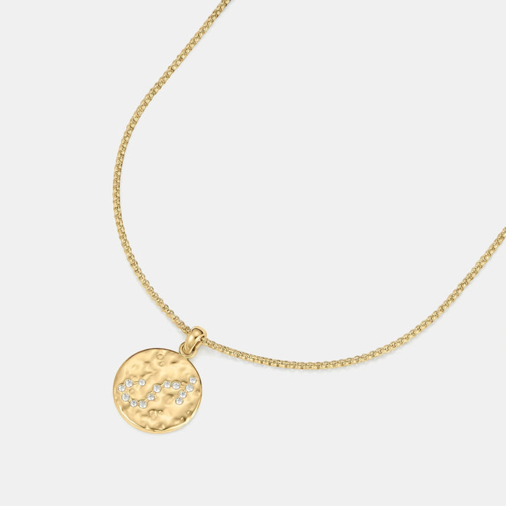 Niche Jewellery gold Scorpio zodiac talisman necklace with hammered finish and crystal accents.