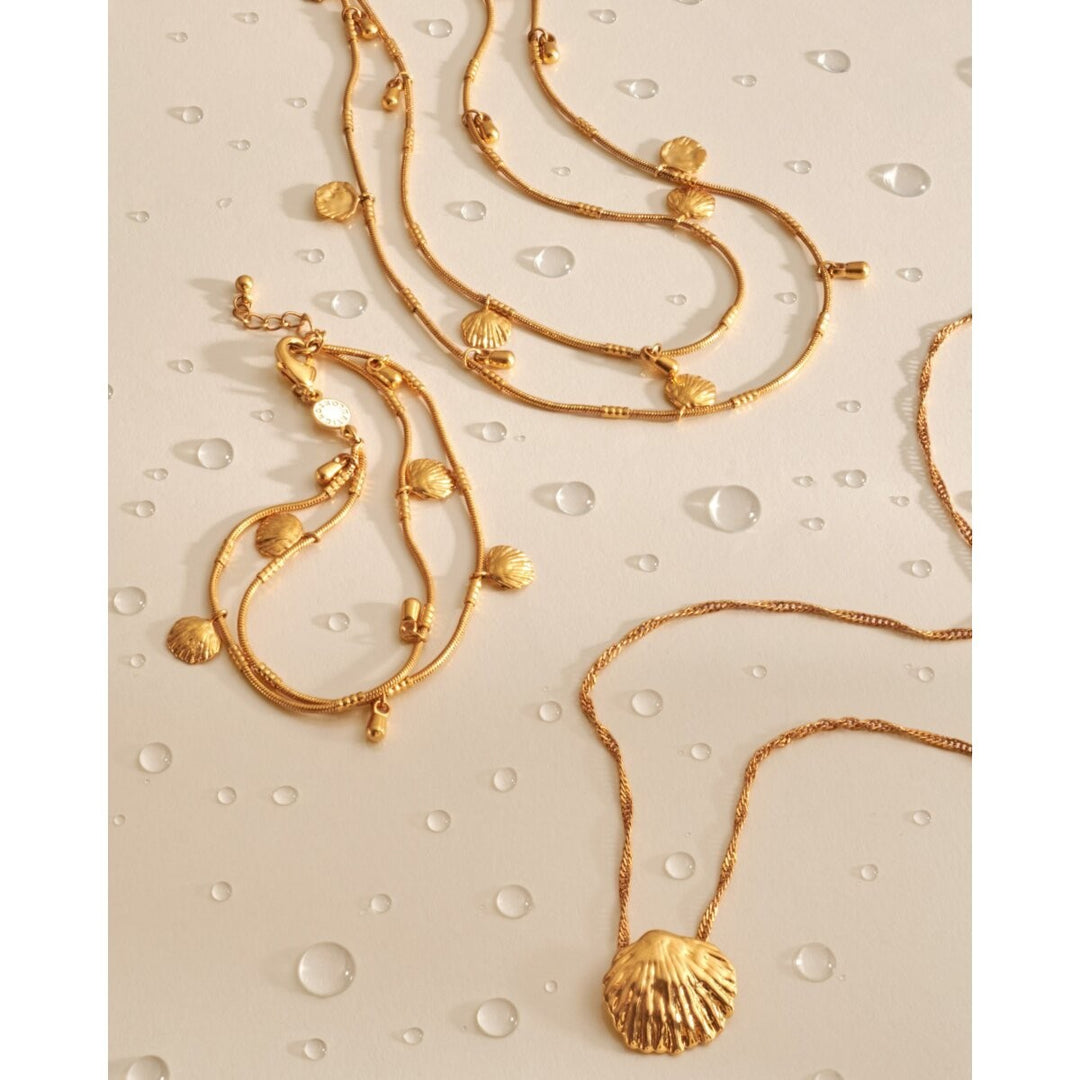Niche Jewellery gold necklace with twist chain and textured shell charm, waterproof 18K Gold PVD coating.