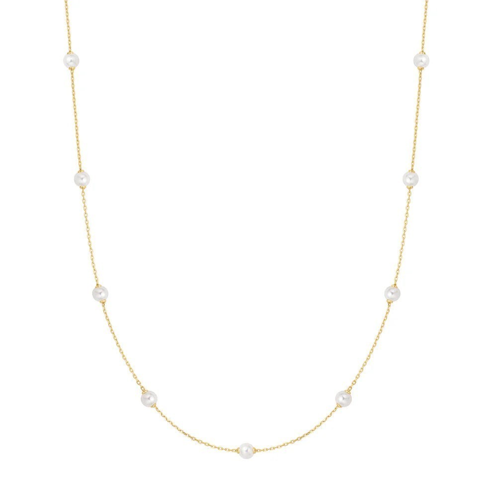Niche Jewellery Ania Haie gold-plated chain necklace featuring spaced white shell pearls for an elegant layered look.